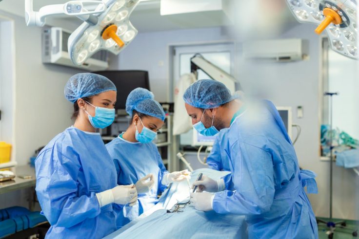 concentrated surgical team operating patient operation theater welltrained anesthesiologist with years training with complex machines follows patient surgery